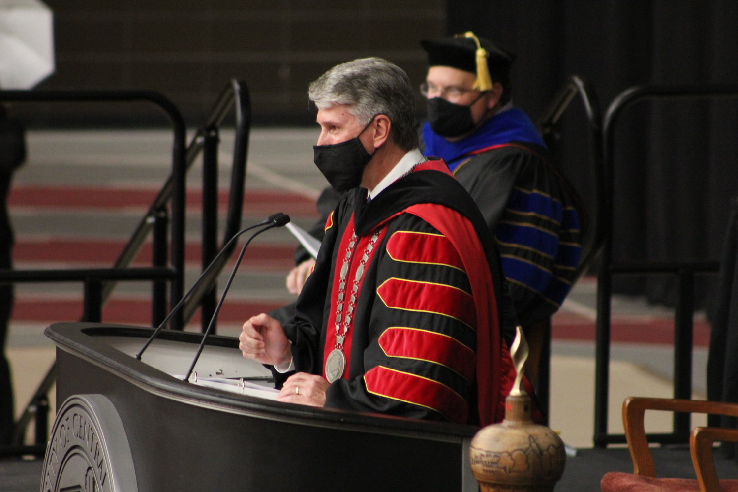 President Roger Best congratulates graduate candidates before conferring their degrees.